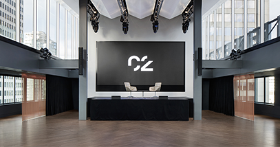 Espace C2 montreal big room with lighting and a big screen and two chairs grande salle avec éclairage et un grand écran et deux sièges